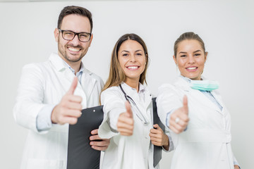 Friendly group of doctors with thumbs up