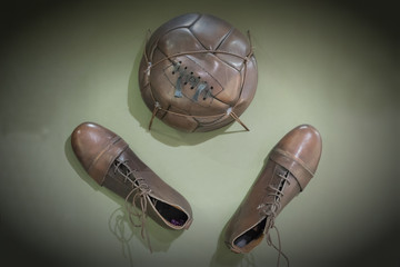 Old football shoes and old ball