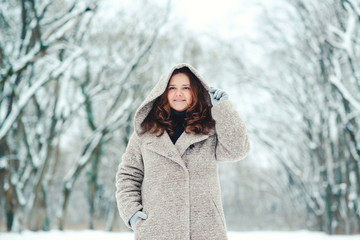 Fototapeta na wymiar Happy young woman in wintertime, walk in nature.