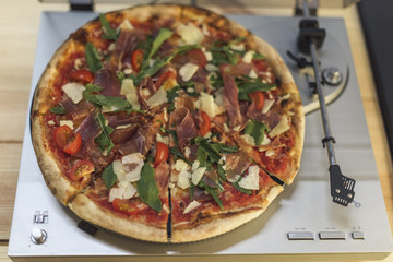 close up view of italian pizza on retro vinyl record player