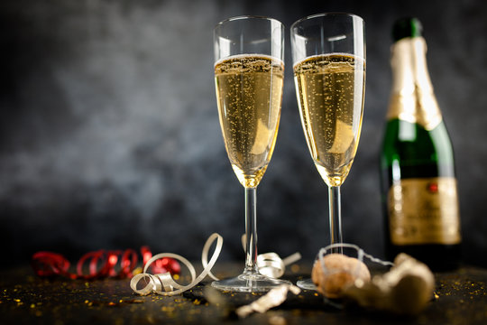 Two champagne glasses in golden glitter