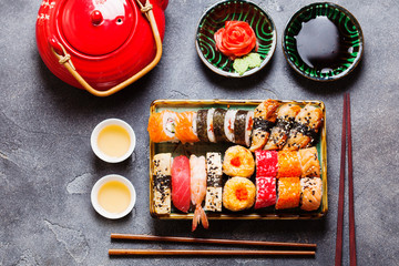 Japanese sushi set nigiri and sushi rolls served with wasabi and ginger, top view