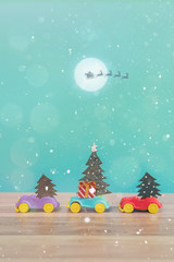 Toy Car with Christmas tree and gift box. Christmas landscape with gifts and snow. Merry christmas and happy new year greeting card with copy-space. Christmas celebration holiday background.