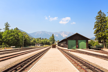 Fototapeta na wymiar Railway station against beautiful blue sky and far mountains