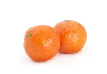 Tangerines with leaves and slices on white background