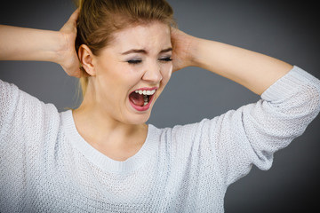 Unhappy woman screaming and yelling in pain
