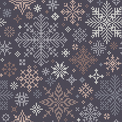 Seamless knitted pattern with gray, beige and white snowflakes