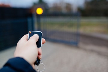 Man opening automatic property gate