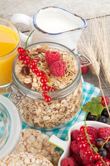 Healthy breakfast with muesli, berries, orange juice and milk