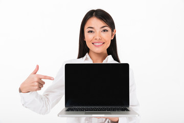 Portrait of a smiling asian businesswoman pointing finger