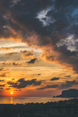 View from balcony of romantic sunset over Mediterranean sea and evening dramatic sky, Alanya, Turkey