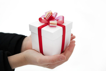 Female hands give you a gift box