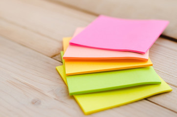 blank sticky note or post note on wood table or wood board.