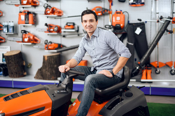 A man is sitting on a lawn mower.