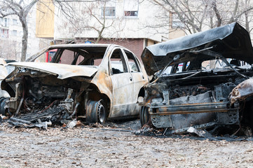 Burnt cars in fire, Totally destroyed cars burned in fire in the war zone or in civil demonstrations close up selective focus