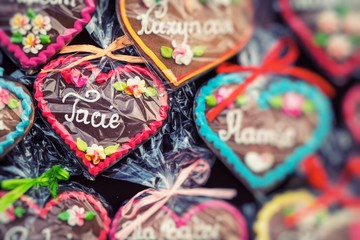 Gingerbread Hearts at Polish Christmas Market. Cracow. Xmas market in Poland. On traditional ginger bread cookies written "Dad, Mum,..." in Polish language.