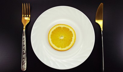 Oranges on a white plate.
