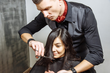 Young woman getting a new haircut at hairdressing salon.