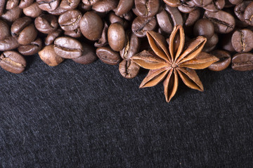 star anise, on the background of coffee with beautiful highlights on the surface of grains