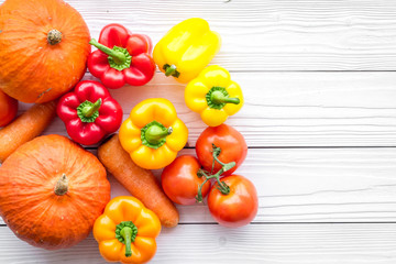 Base of healthy diet. Vegetables pumpkin, paprika, tomatoes, carrot on white wooden background top view copyspace