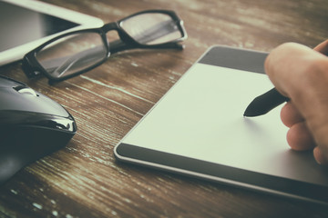 Graphic designer working on digital tablet.