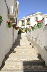 Fototapeta na wymiar Stairs along the alley in Estepona, Andalusia, Spain
