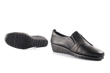 Female black leather shoe on white background, isolated product, comfortable footwear.