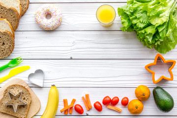 Prepare healthy breakfast for children. Meal with vegetables and fruits. White wooden background top view copyspace