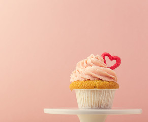 Garnished sweet cupcake on stand