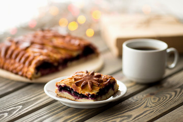 piece of cake on the Christmas table. Christmas Lights and Decor.