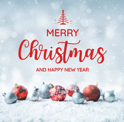 Merry christmas and happy new year text with christmas ball (ornament) on snow background.For new year,celebration concepts