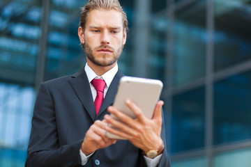 Portrait of a businessman using his tablet