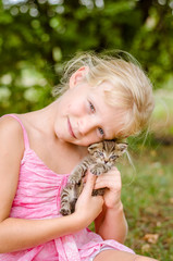 lovely girl caressing a beautiful little cat