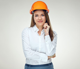 Portrait of young confident businesswoman wearing builder helmet