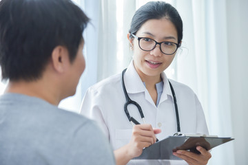 Fototapeta premium Female Doctor examining male patients.