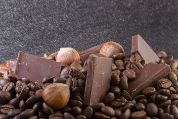 Close-up, roasted coffee seeds, tubberry, cinnamon sticks and chocolate.