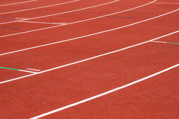 red running track on athletic stadium background texture