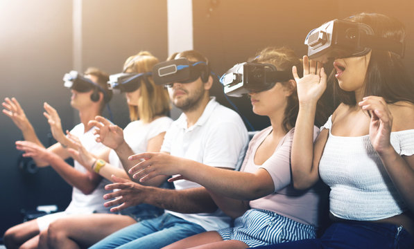 scared girl on virtual reality attraction sitting with another people