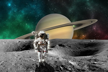 Astronaut on Planet Saturn from Saturn moon surface. Elements of this image furnished by NASA © pe3check