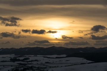 Sunset on meadow with snow during winter. Slovakia