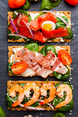 Brushetta set on dark background. Variety of small sandwiches. D