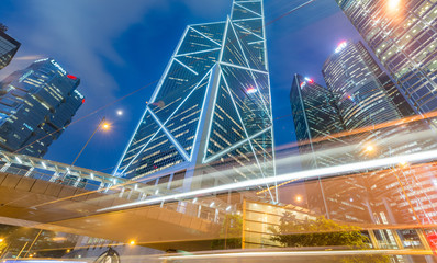 Fototapeta na wymiar HONG KONG - MAY 12, 2014: Downtown skyscrapers with road car light trails at night. Hong Kong attracts 25 million people annually