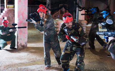 Young people playing paintball