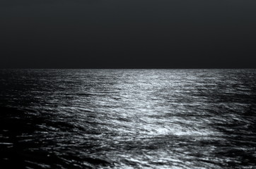  Sea horizon at night. moonlight on the waves. Long exposure. Beautiful landscape. black and white toning