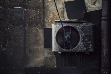 Charred air conditioning on the wall after a fire