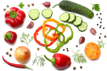 mix of slice of tomato, basil leaf, garlic, sweet bell pepper and spices isolated on white background. top view