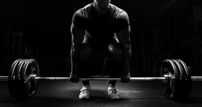 Huge man is preparing to perform an exercise called deadlift.