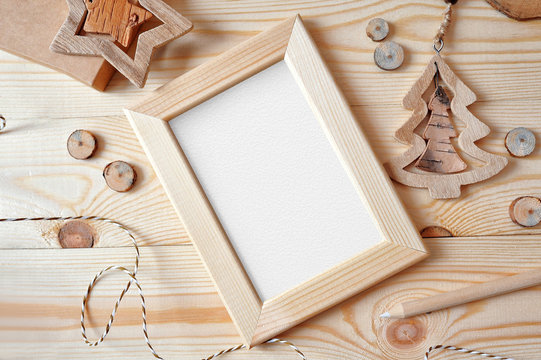 Christmas background with a wooden frame and a star and tree. Flat lay, top view photo mockup, with space for your text