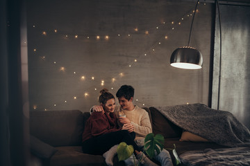 Naklejka premium Romantic couple in cozy living room