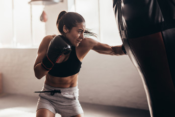 Woman training boxing at gym
